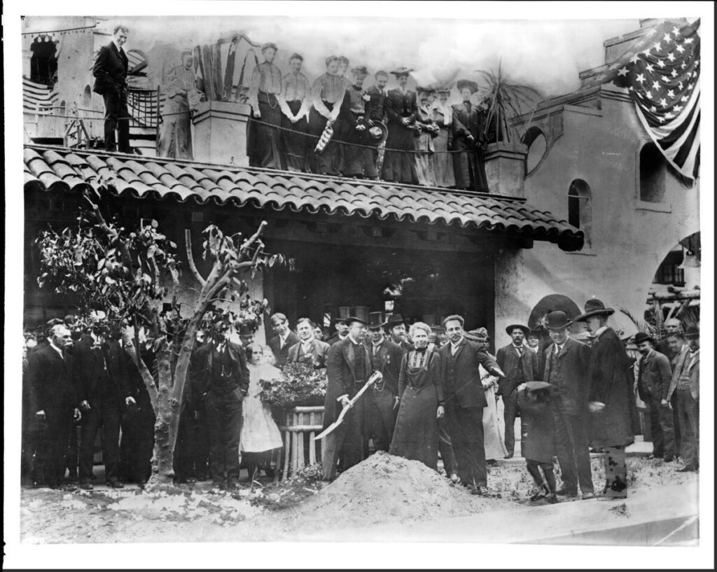 Portrait of Theodore Roosevelt planting an orange tree in front of the Mission Inn